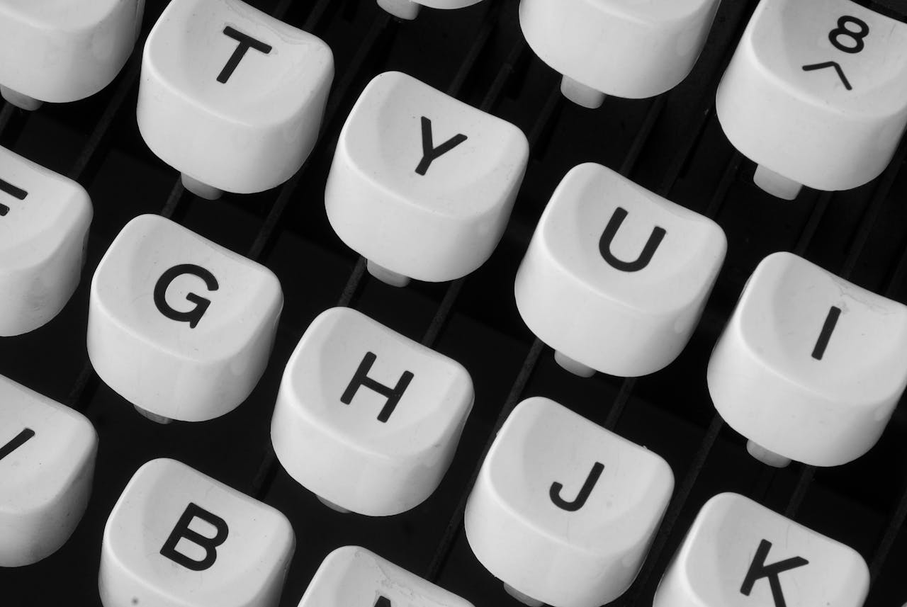 Home Black and white close-up of retro typewriter keys showcasing vintage charm.
